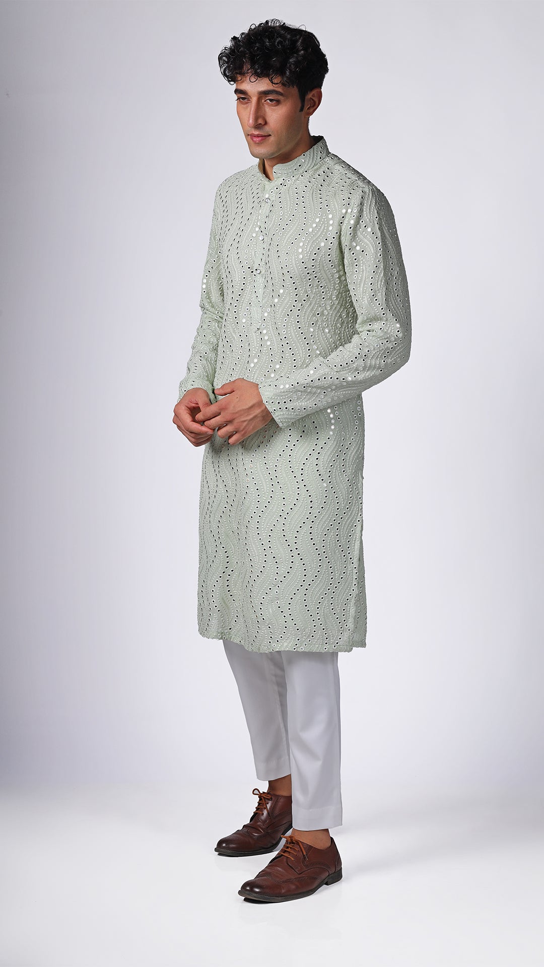 Different angle of Mint Green Kurta, showcasing intricate mirror embroidery. Paired with white slim trousers and white sneakers