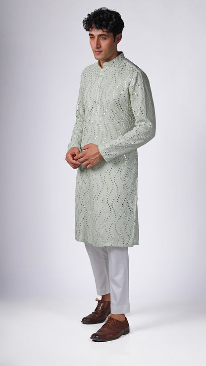 Different angle of Mint Green Kurta, showcasing intricate mirror embroidery. Paired with white slim trousers and white sneakers