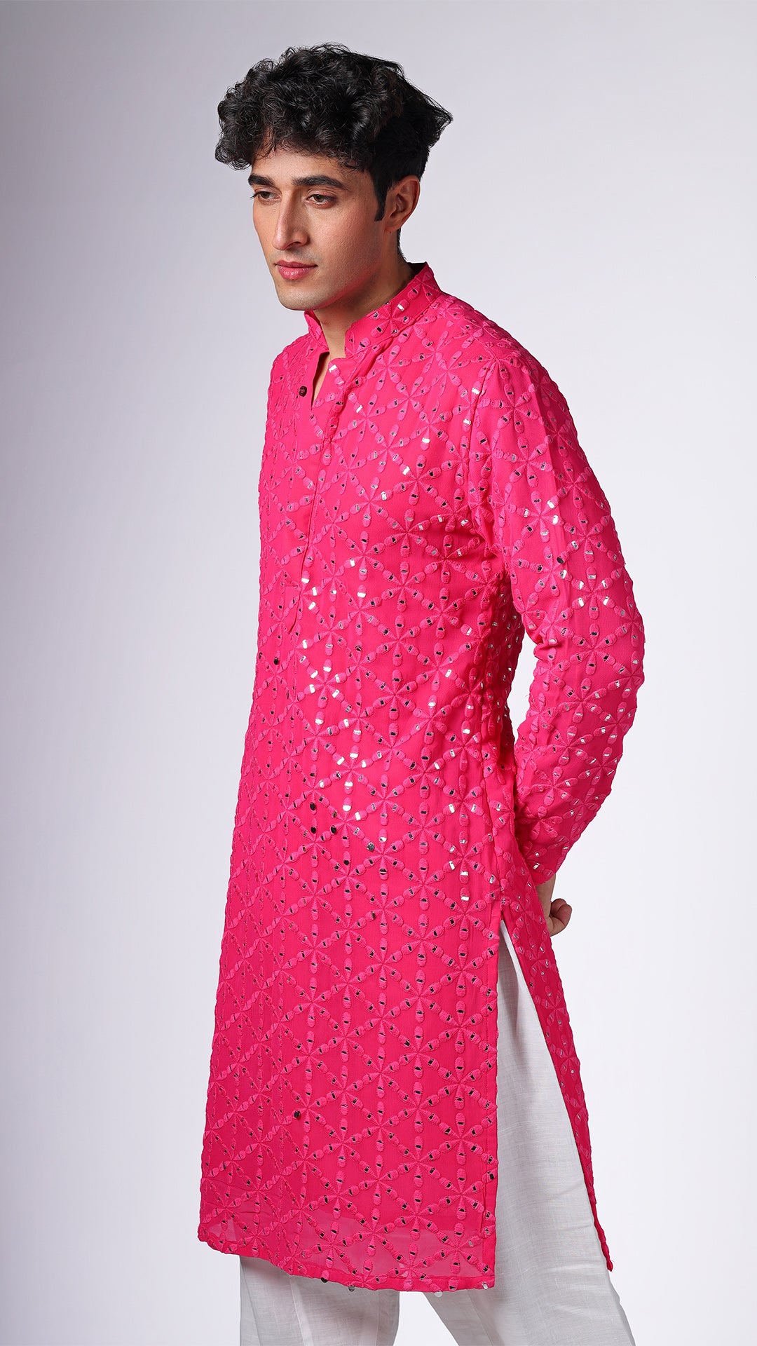 Close-up of Hot Pink Kurta with Sequin Embellishments, highlighting intricate details. Model styled with salwar