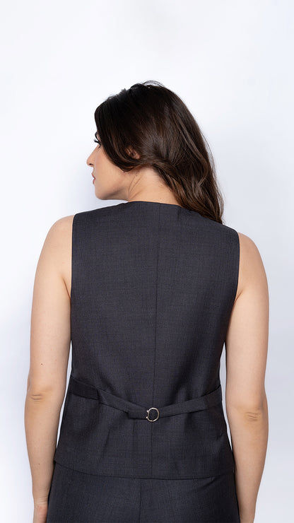 A modern women's waistcoat in dark grey, featuring back side's fine tailoring. Ideal for corporate wear and formal styling.