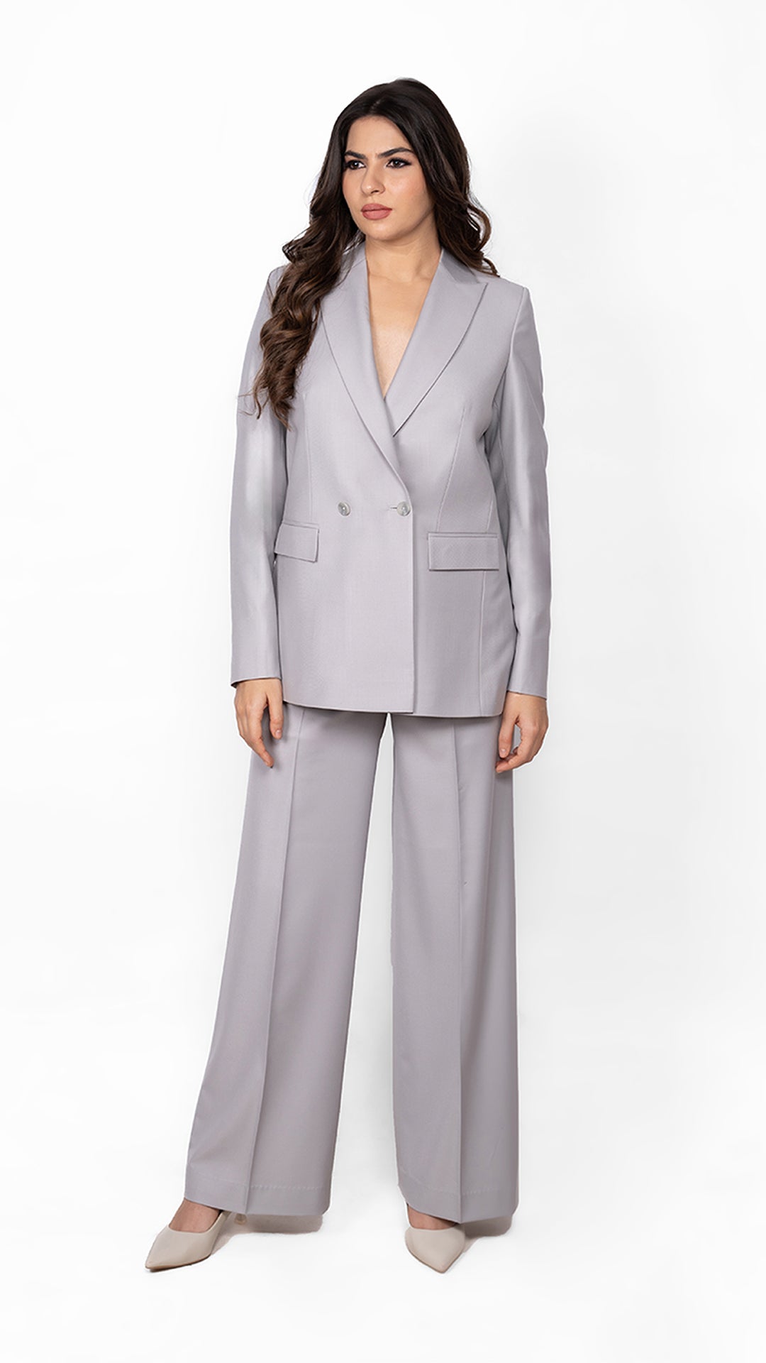 A sophisticated two-piece suit in light grey, crafted with a structured double-breasted blazer and streamlined trousers for effortless power dressing.