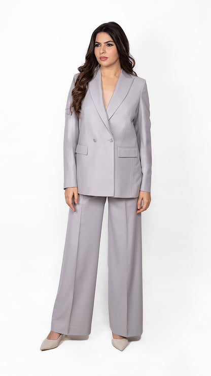A sophisticated two-piece suit in light grey, crafted with a structured double-breasted blazer and streamlined trousers for effortless power dressing.