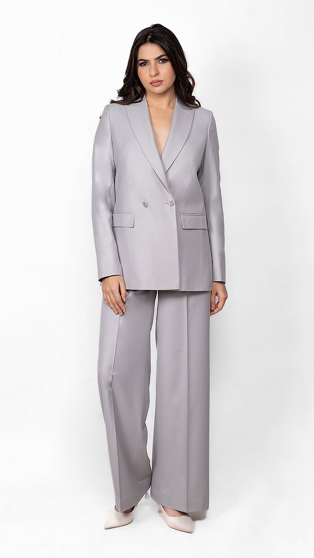 A contemporary light grey suit featuring a double-breasted blazer with a 2-button closure and perfectly tailored trousers for a sleek, refined look.