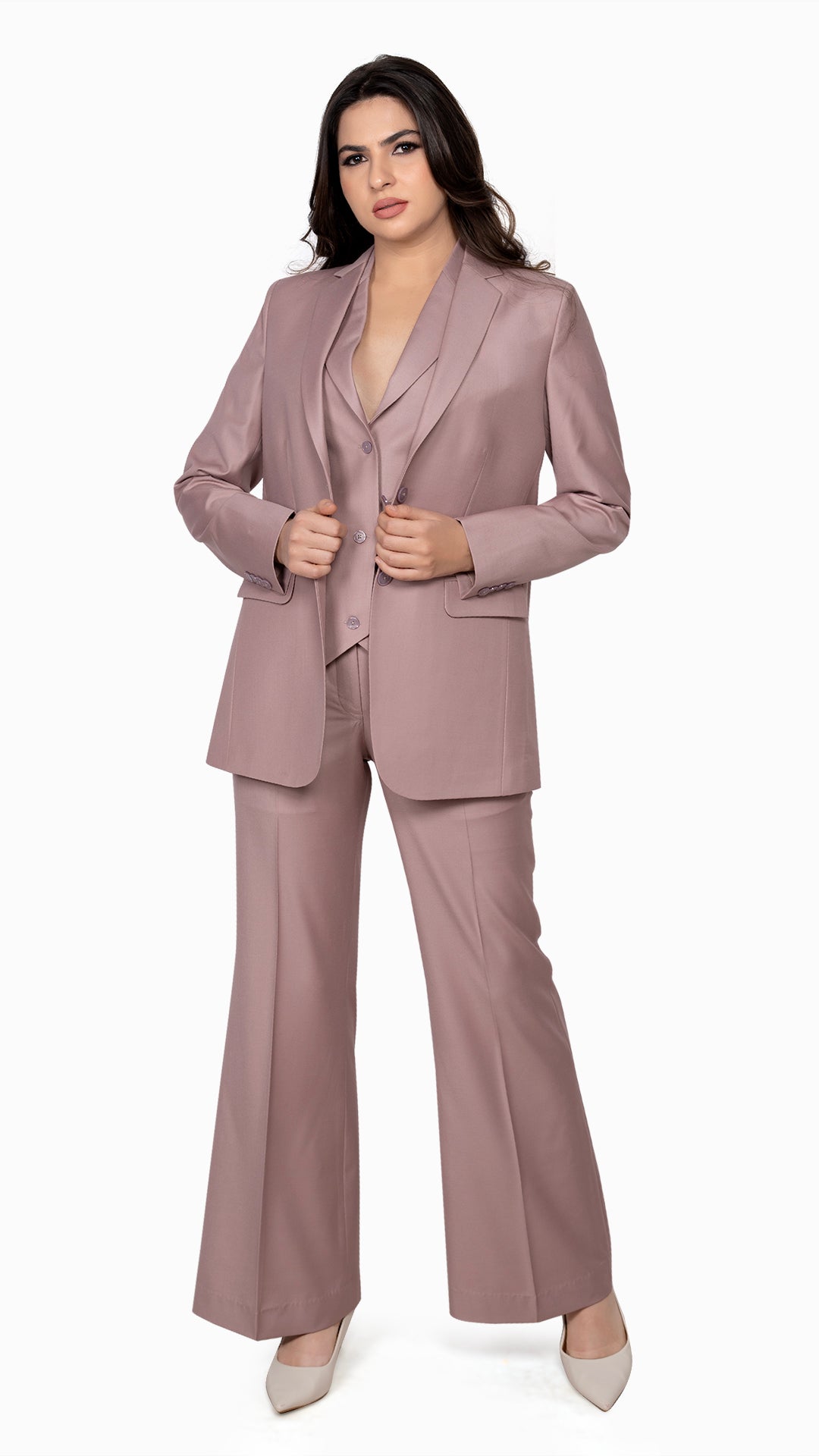 A structured three-piece suit in onion pink, including a refined blazer, notch lapel waistcoat, and flared trousers. Designed for a statement look.