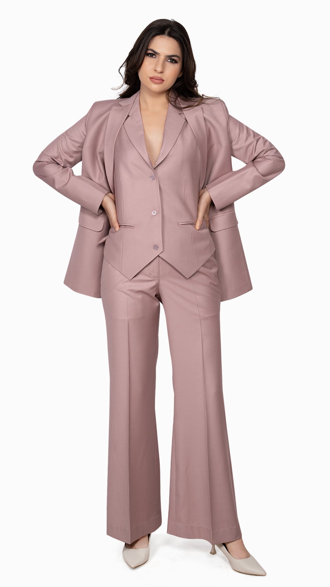 A chic three-piece suit in onion pink, featuring a sharp blazer, tailored waistcoat, and bell-bottom pants. A modern take on classic tailoring.

