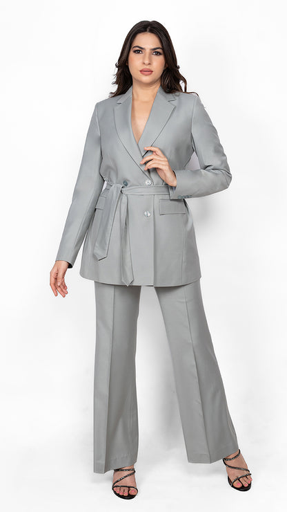 A sophisticated suit in mint green, featuring a notch lapel, belted waist, and precisely tailored trousers for effortless style.