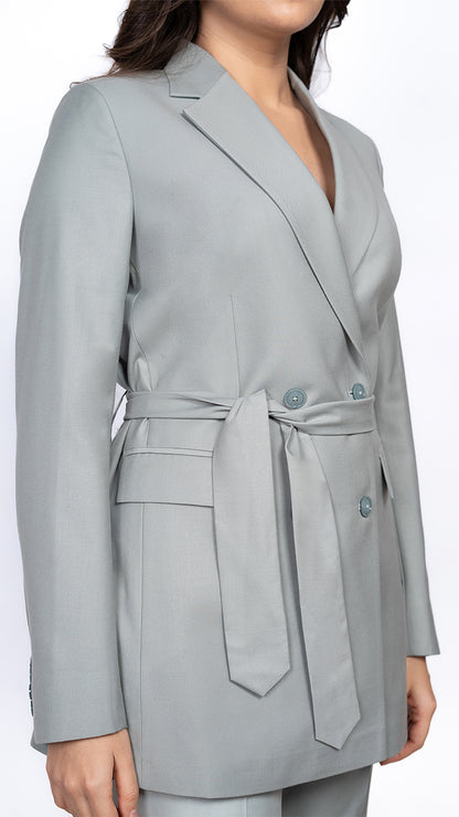 A close-up of the belted waist on the mint green blazer, showcasing its structured yet flattering fit for an elevated power dressing aesthetic.