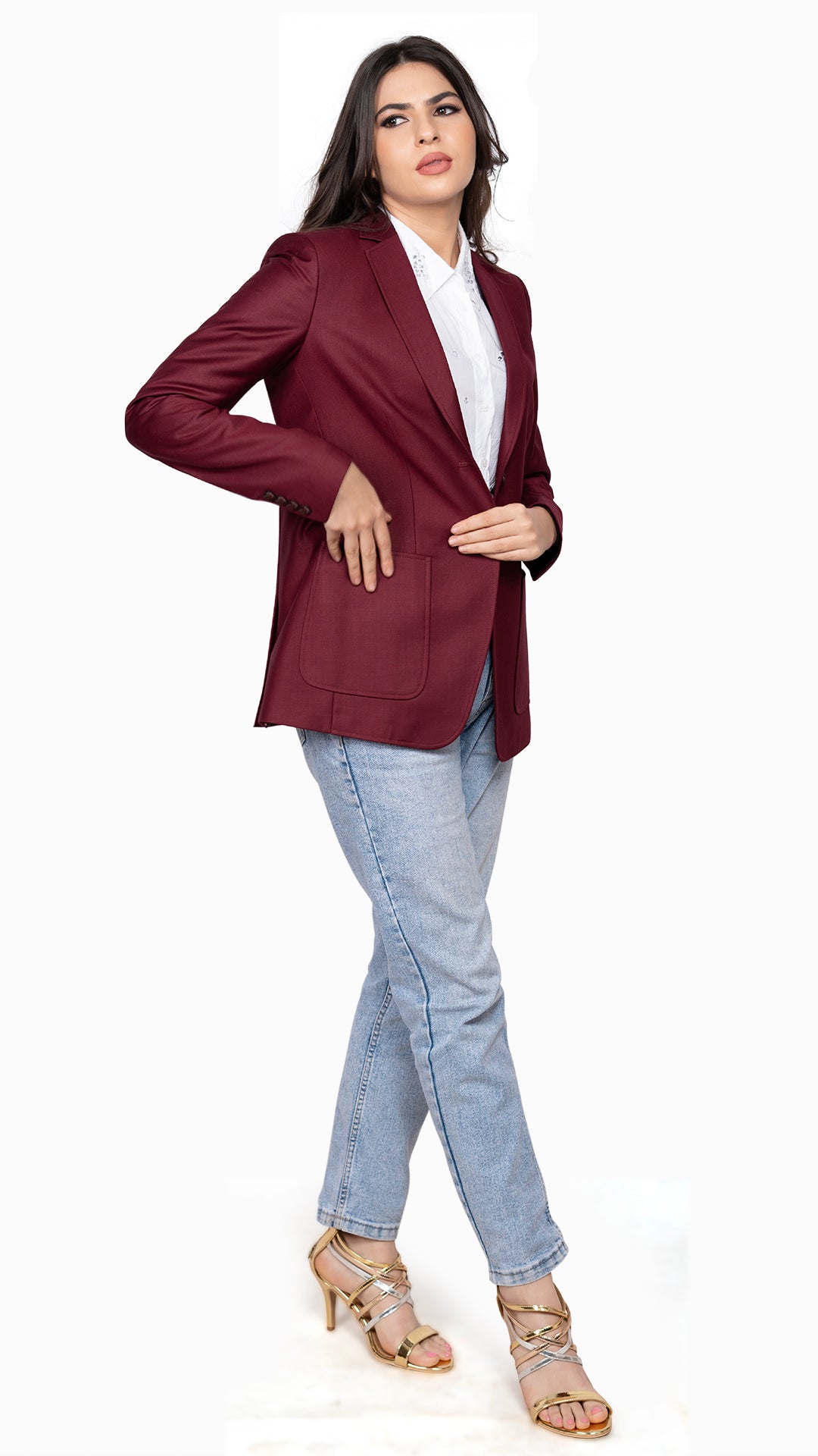 A tailored maroon blazer styled with denim jeans, offering a polished yet effortless aesthetic.