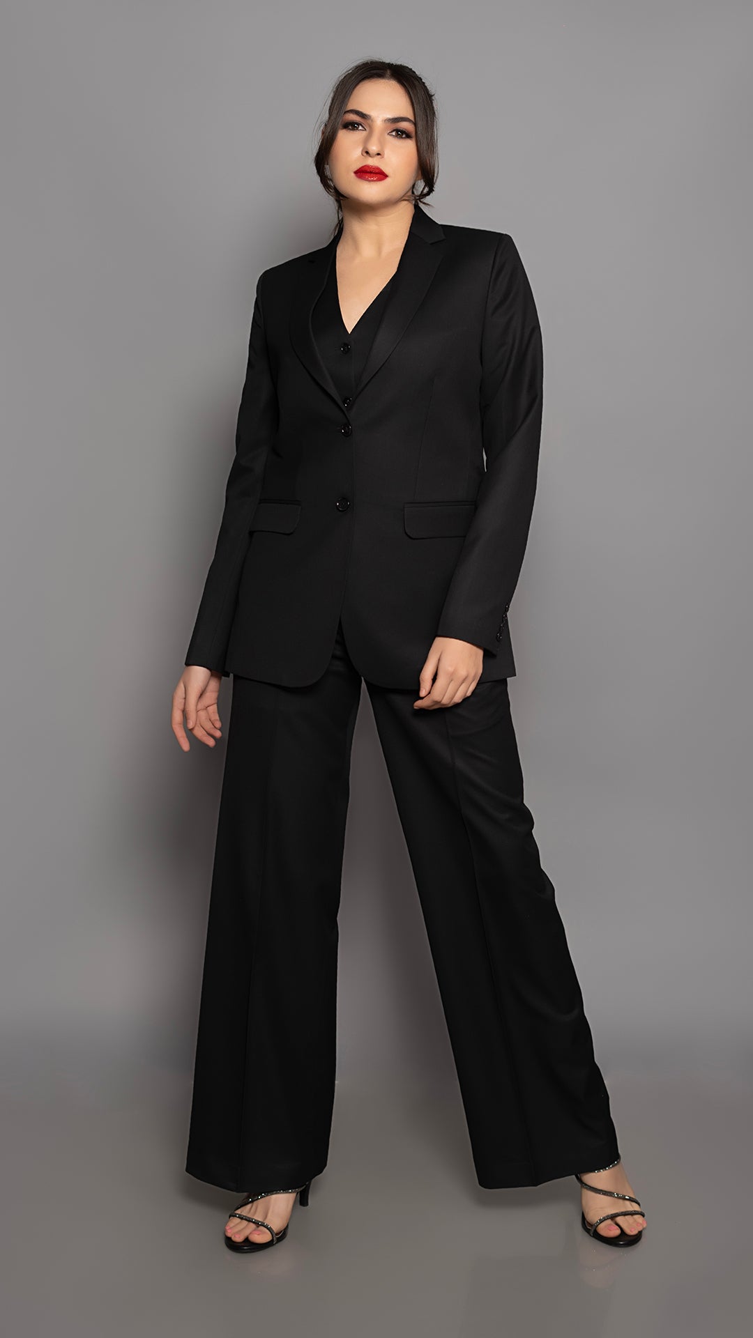 A modern black blazer with impeccable tailoring, strong shoulders, and a sophisticated notch lapel. The ultimate power dressing essential.

