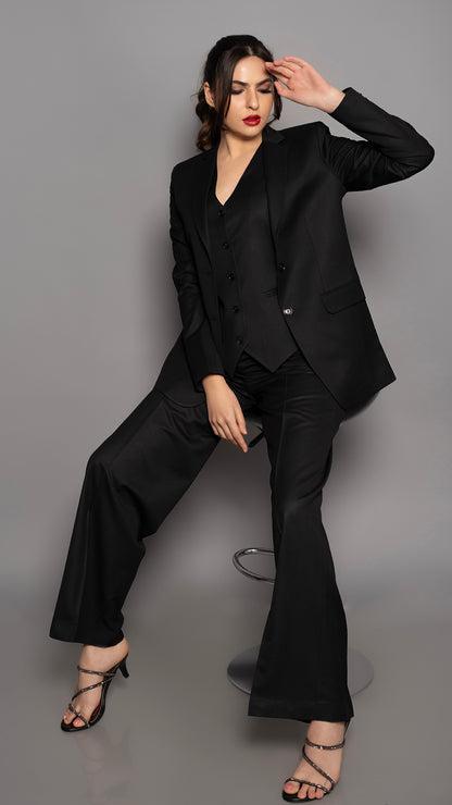 A bold three-piece suit in black, with a sharp lapel blazer, fitted waistcoat, and straight trousers. The perfect mix of confidence and elegance.