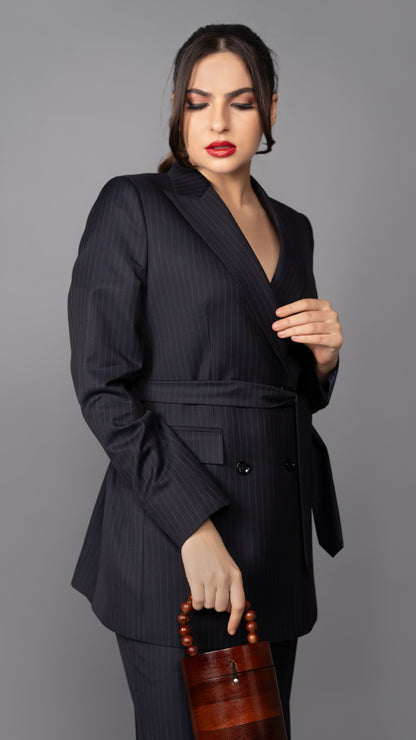 A contemporary blue pinstriped blazer, featuring a classic peak lapel and a waist-cinching belt, redefining modern formalwear.