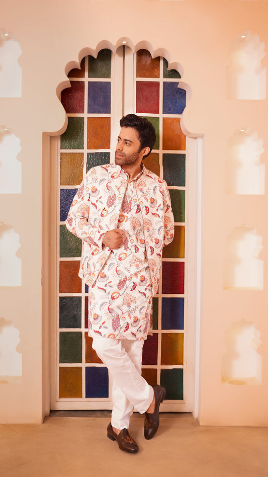 Man in animal motif bomber jacket set standing in front of a colorful stained glass window.