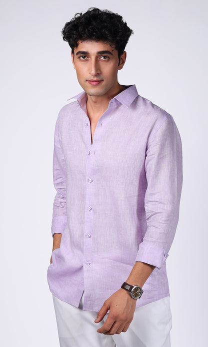 Model in a lavender linen shirt, standing with hands in pockets, showcasing a casual elegance.