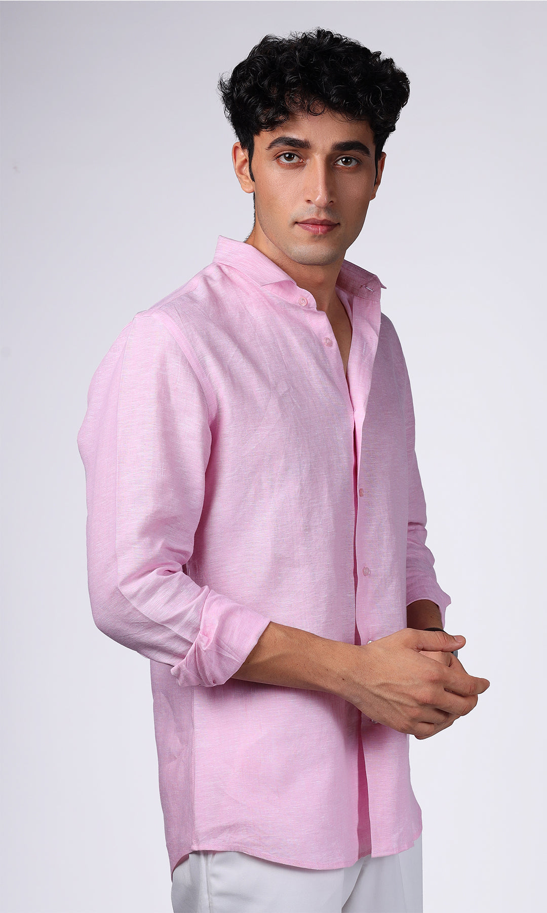 Side profile of a model in a pink linen shirt, focusing on the fit and tailoring