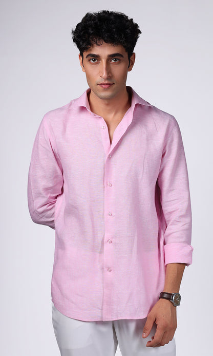 Close-up of a pink linen shirt on a model, emphasizing the deep, rich color and fabric quality